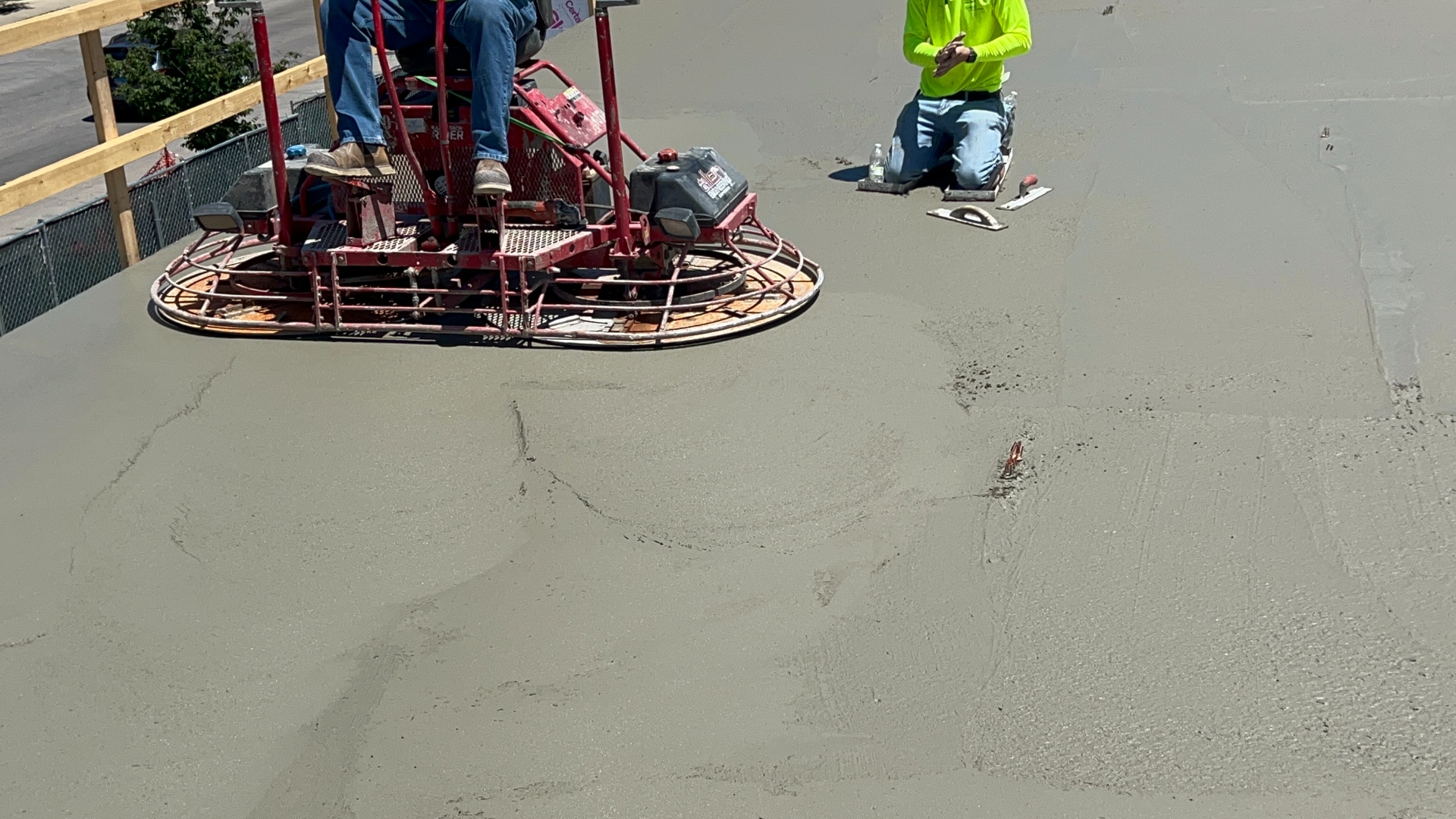 Riding trowel on freshly poured concrete deck — Stub-EASE II™ caps in the slab, trowel passes freely over the surface